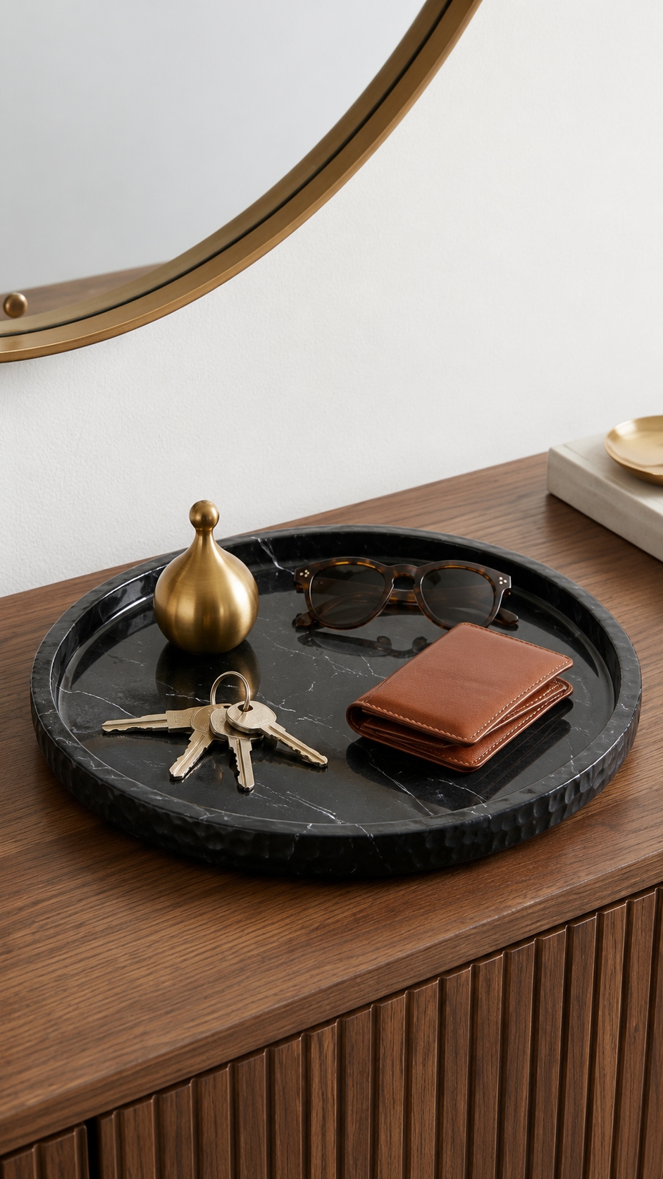 Black marble tray with perfume, folded white towel and gold bracelets