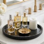 Black marble vanity tray styled with luxury perfume bottles on a bathroom counter