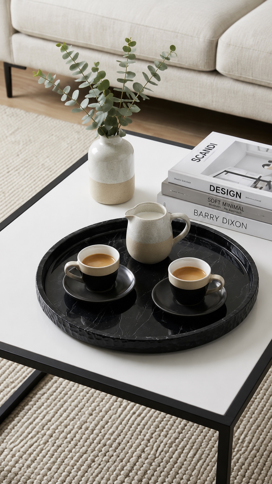 Round black marble tray with espresso cups and ceramic milk jug