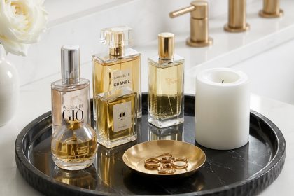 Black marble vanity tray styled with luxury perfume bottles on a bathroom counter