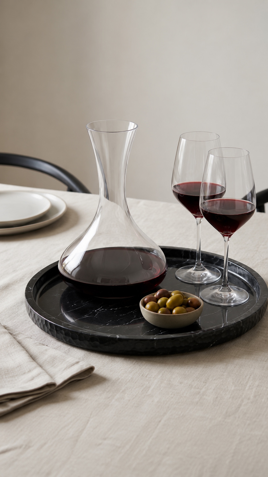 Round black marble tray with pillar candle, book and espresso cup