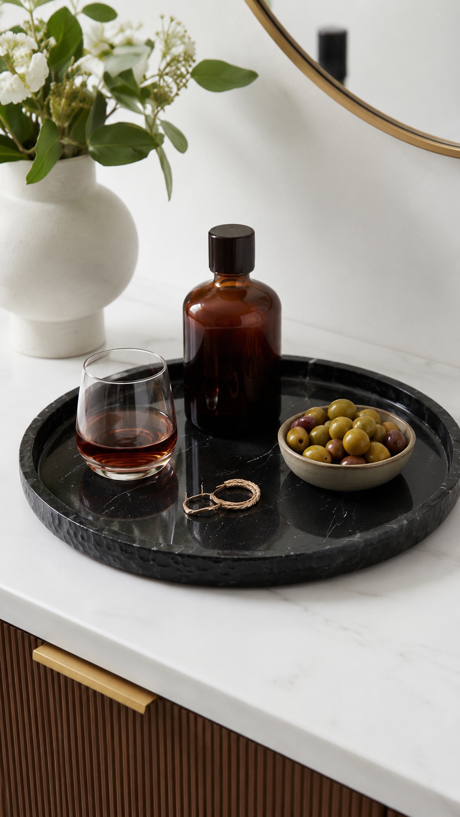 Black marble catchall tray with brass ornament, sunglasses, wallet and keys