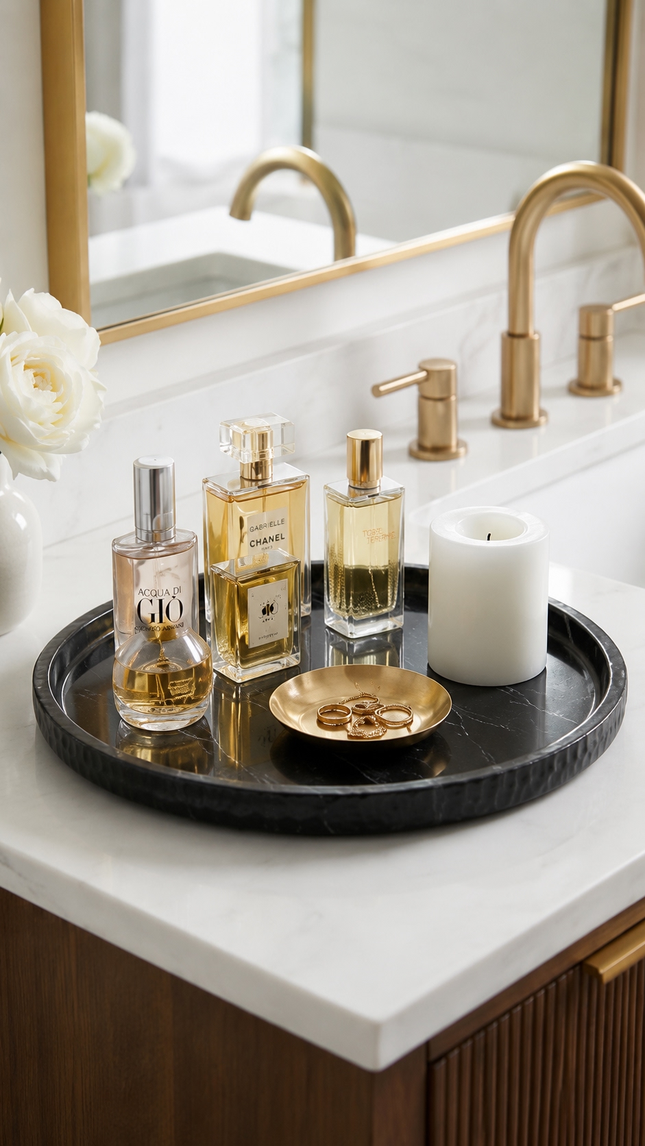 Black marble vanity tray styled with luxury perfume bottles