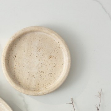 Extreme close-up of white marble tray surface showing natural stone texture and subtle veining