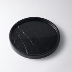 Dark marble round tray isolated on white background, clear product view showing full shape