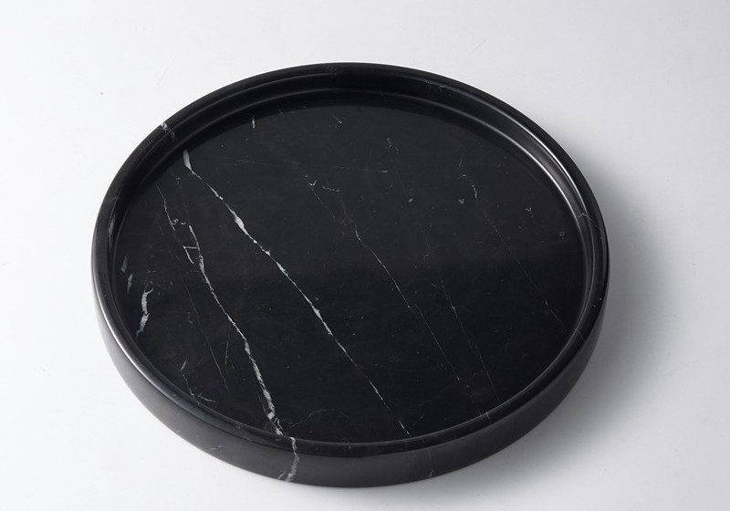 Dark marble round tray isolated on white background, clear product view showing full shape