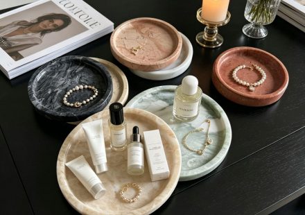 Black marble round tray with hand-hammered textured edge, angled view showing craftsmanship detail