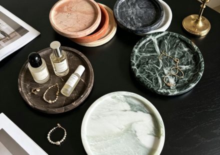 Angled perspective of dark natural marble round tray showing depth and edge craftsmanship