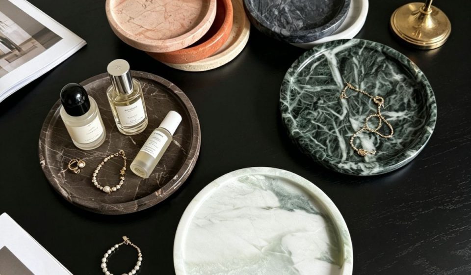 Angled perspective of dark natural marble round tray showing depth and edge craftsmanship