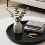 Top-down view of Nero Marquina hammered edge tray with fresh eucalyptus and decorative objects