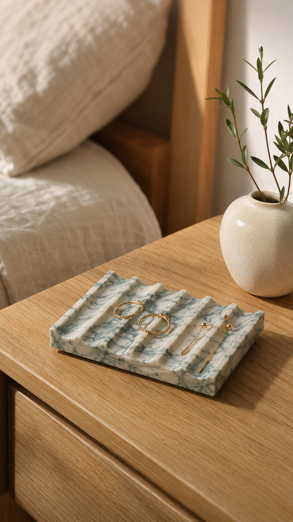 A marble soap dish styled on a stone bathroom counter