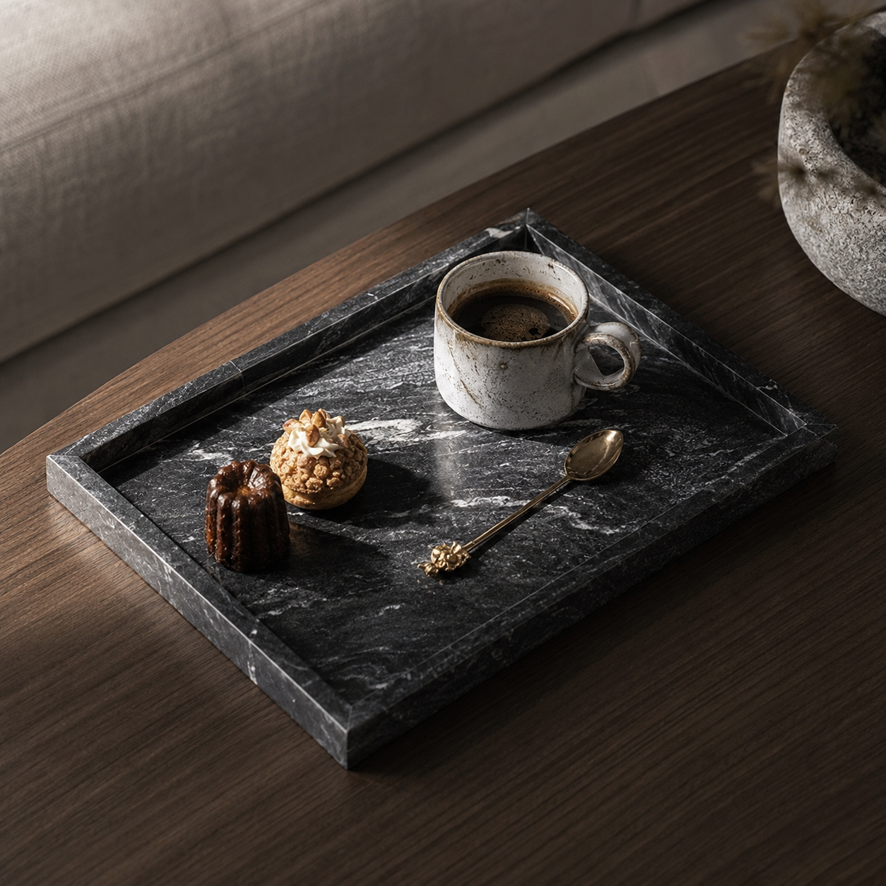 A marble square tray styled with a watch and rings