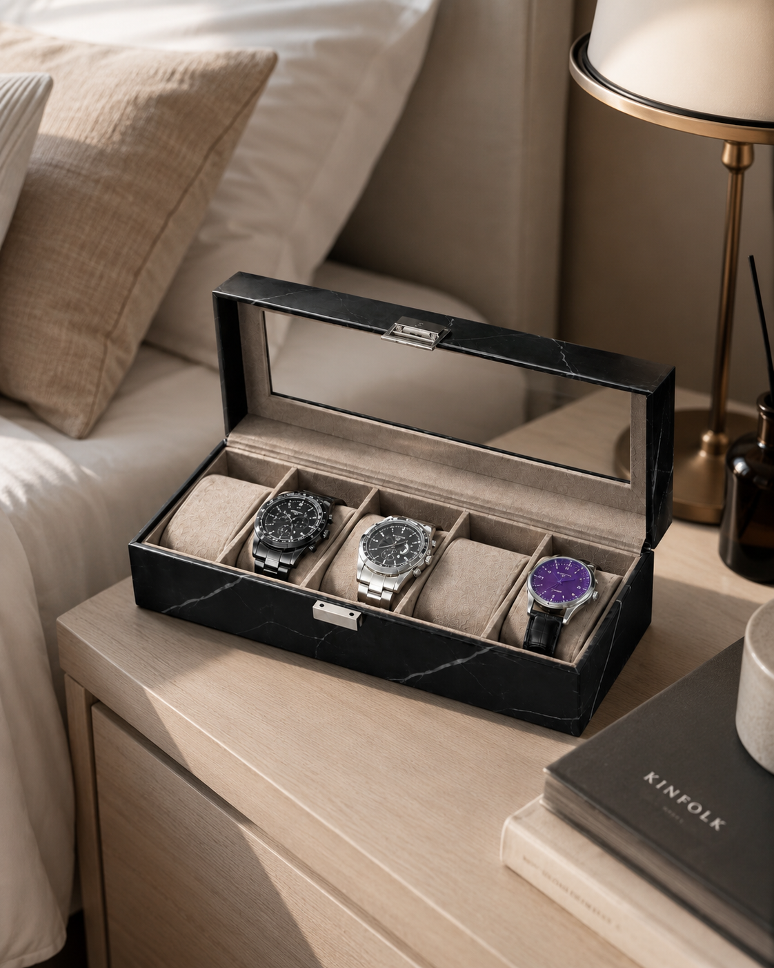 Black marble watch box on a bedside table